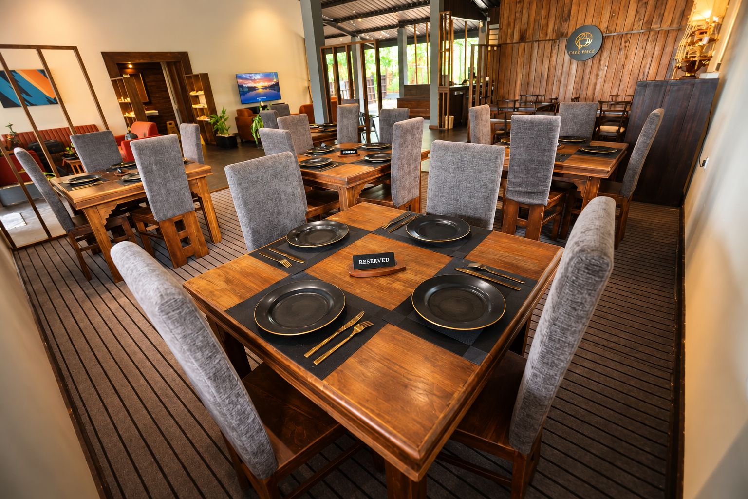 A restaurant with multiple tables, each set with plates, cutlery, and a 'RESERVED' sign.