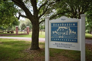 A sign for Beaubassin Farm & Gardens, indicating it is a bed and breakfast event venue. - Garand Suite: Experience Ville Platte’s Heritage in Comfort (Sunset)