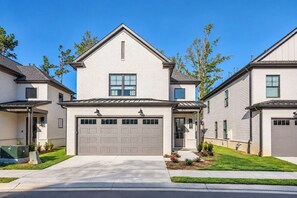 A residential building with a central garage, a pitched roof, and a symmetrical facade. - The Pete's Sake, Pool + Grill, 4BR by VDV (Oxford)