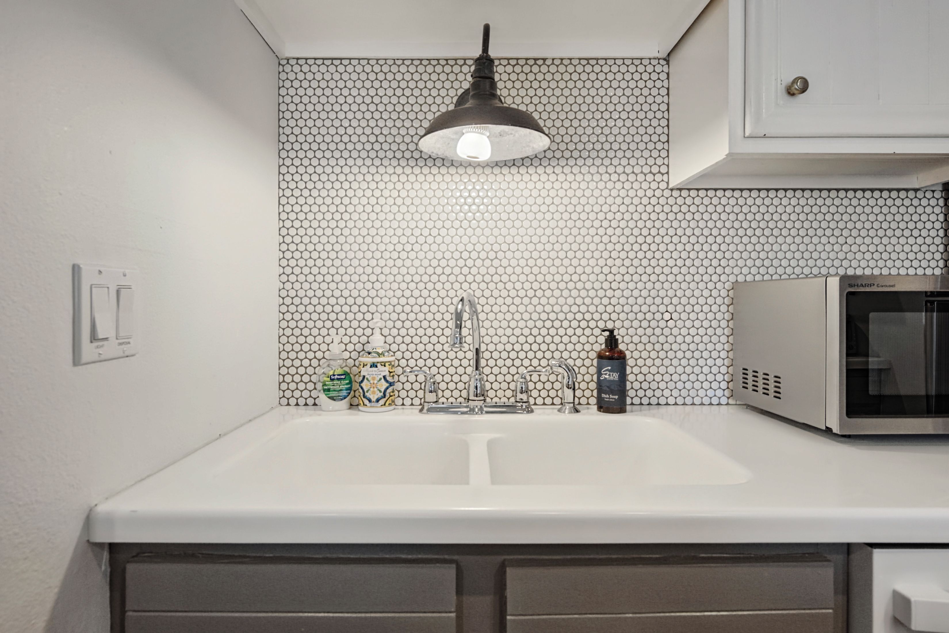Your stylish kitchenette features a chic penny-tile backsplash, modern pendant lighting, and everything you need for light meal prep during your stay.