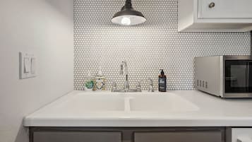 Your stylish kitchenette features a chic penny-tile backsplash, modern pendant lighting, and everything you need for light meal prep during your stay.