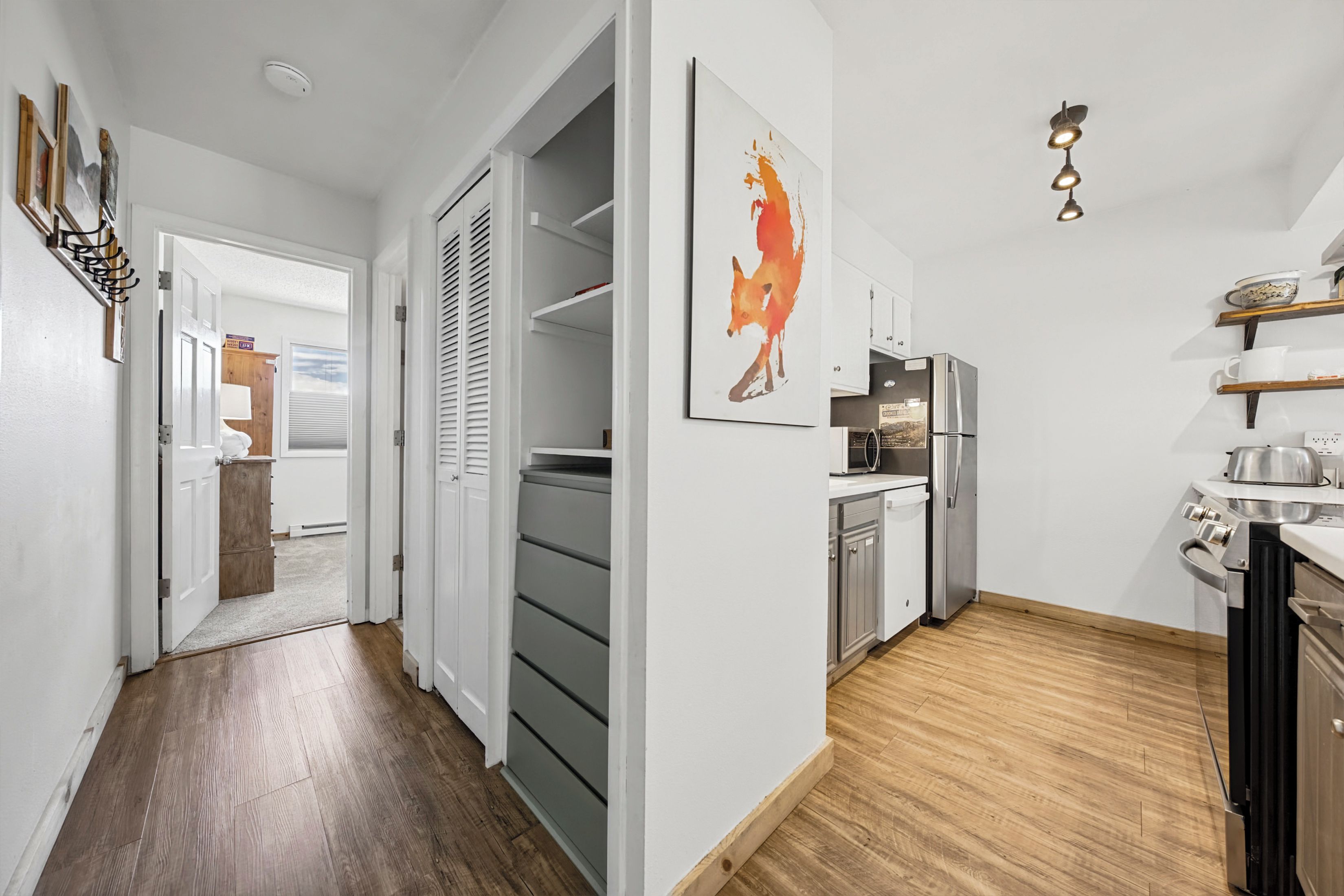 A modern kitchen with a microwave, refrigerator, and stove.