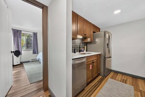 Your fully equipped kitchen makes meal prep a breeze, with stainless appliances and sleek counters ready for cooking at home. - Meadow Ridge Court 22 Unit 15 clubhouse, private deck, views (Fraser)