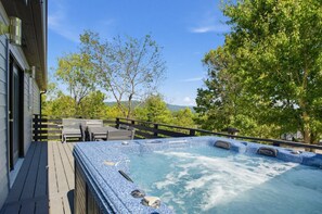 A hot tub on a wooden deck with a view of trees and hills. - Asheville Mountain Retreat w Hot Tub & Game Room! (Asheville)