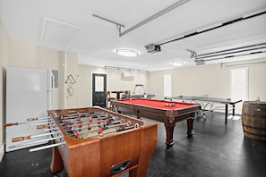 A room with a foosball table, pool table, and a bar area. - Asheville Mountain Retreat w Hot Tub & Game Room! (Asheville)