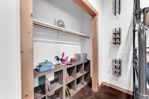 A storage area with shelves, a fan, and a metal bucket. - Branson Lodge, Hot Tub, 6 King Rooms, 2 Bunk Rooms (Branson)