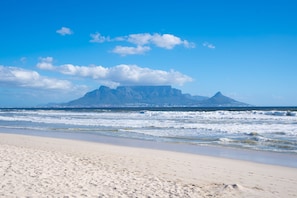 A beach with a mountain in the background. - The Bay A801 - Two Bedroom Apartment, Sleeps 4 (Cape Town)