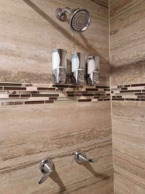 A bathroom with a shower, three hand dryers, and a tiled floor. - Lovely blue 1-bedroom apartment with free parking (Laredo)