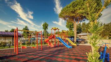 A playground with swings, slides, and climbing structures.