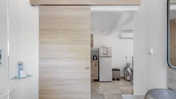 A modern kitchen with a built-in oven, a refrigerator, and a sink.
