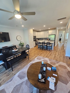 A modern kitchen with white cabinets, a microwave, and a refrigerator. - Lakefront Bliss on Lake Greenwood - 3BR Condo with Stunning Views (Greenwood)