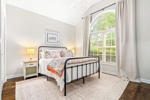 A bedroom with a bed, bedside tables, a window with curtains, and a picture on the wall. - New! 3BR/2BA House - 0.8 Mi From Downtown Auburn (Auburn)