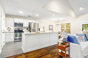 A modern kitchen with white cabinetry, stainless steel appliances, and a wooden island. - New! 3BR/2BA House - 0.8 Mi From Downtown Auburn (Auburn)