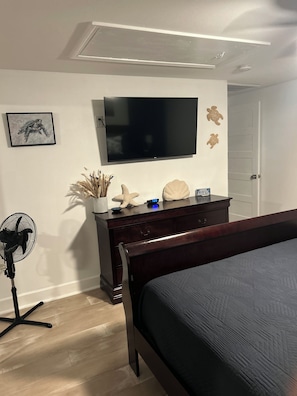 A bedroom with a bed, a dresser, a TV, and a fan. - Chasing Sunsets
Cozy 1-bedroom  2 bath  with 2 beds and All new furnishings. (Galveston)