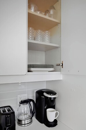 A kitchen area with a coffee maker, a toaster, and a glass carafe on the counter. - CN Tower View 2BR/2BA | Free Parking Included | Parking Available (Toronto)