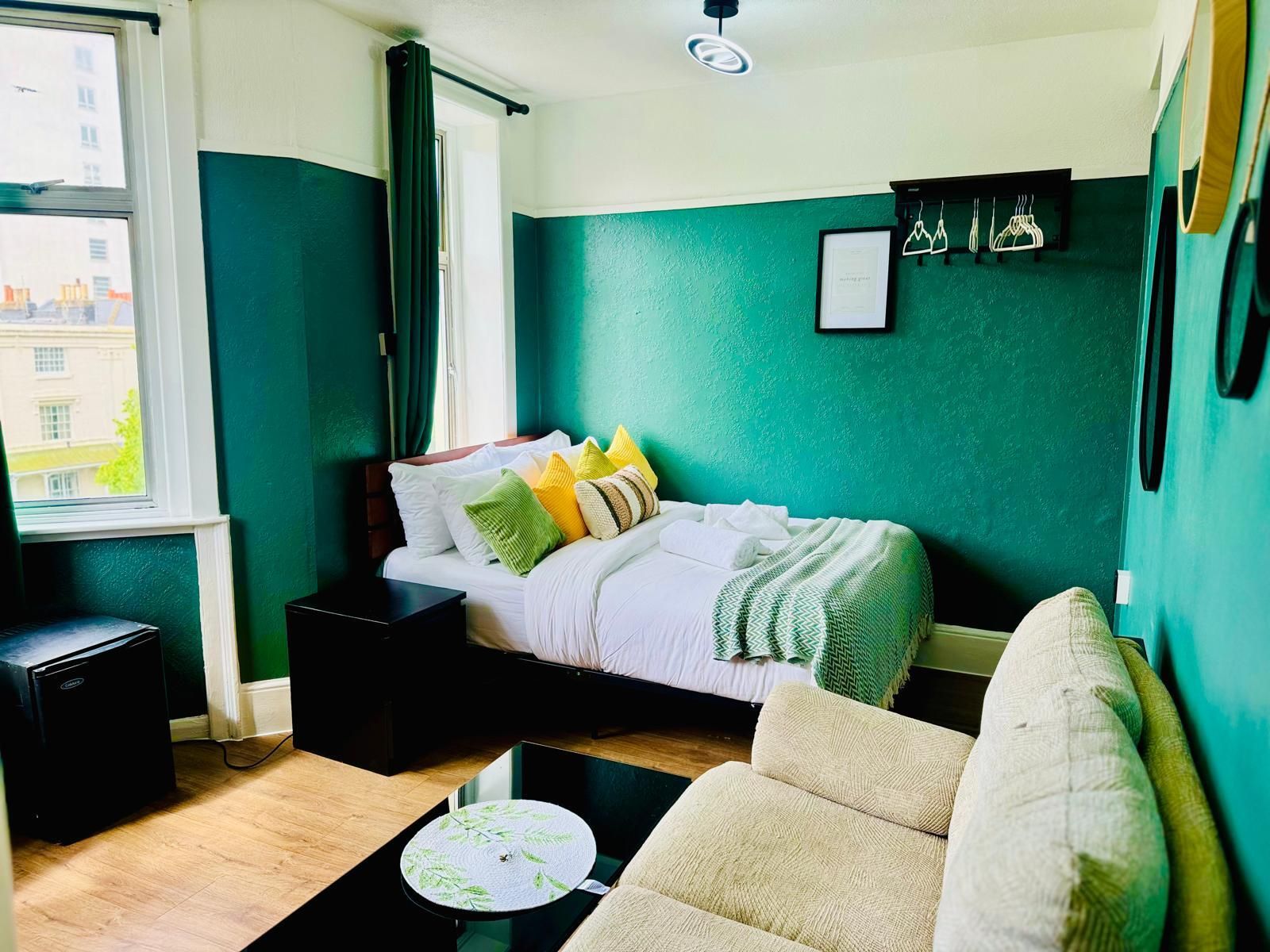 A bedroom with a bed, bedside table, and a chair.