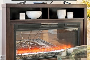 A fireplace with a glass door, a wooden mantel, and a white bowl on the mantel. - Spacious Toronto nest 6BR/4.5BA, Free Parking, 2 kitchens near 401 & Zoo (Toronto)