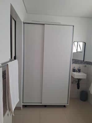 A bathroom with a white shower enclosure, a sink, and a mirror. - Nest24: Comfortable King Size Bed Apartment Near Gold Reef City (Johannesburg South)