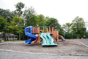 A playground with slides and climbing structures. - Stunning Poconos Mountain Retreat with Spacious Rooms, Pool Table and Family Fun (Tobyhanna)