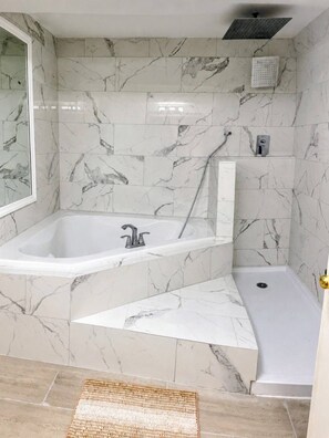 A bathroom with a freestanding bathtub, a shower, and a walk-in shower. - Jamesville Luxury Retreat Pool, Hot Tub & 4BR (Jamesville)