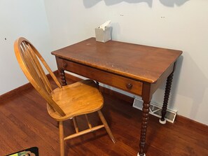 A wooden desk with a chair, a radiator, and a wall-mounted shelf. - Family Home with Large Kitchen & Sun Porch (Erie)