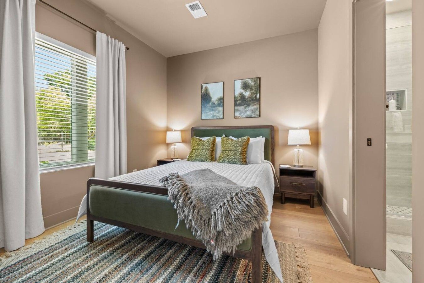 Bedroom 1 features a comfortable queen bed, closet, full length mirror and a private attached bathroom. Located on the first floor.