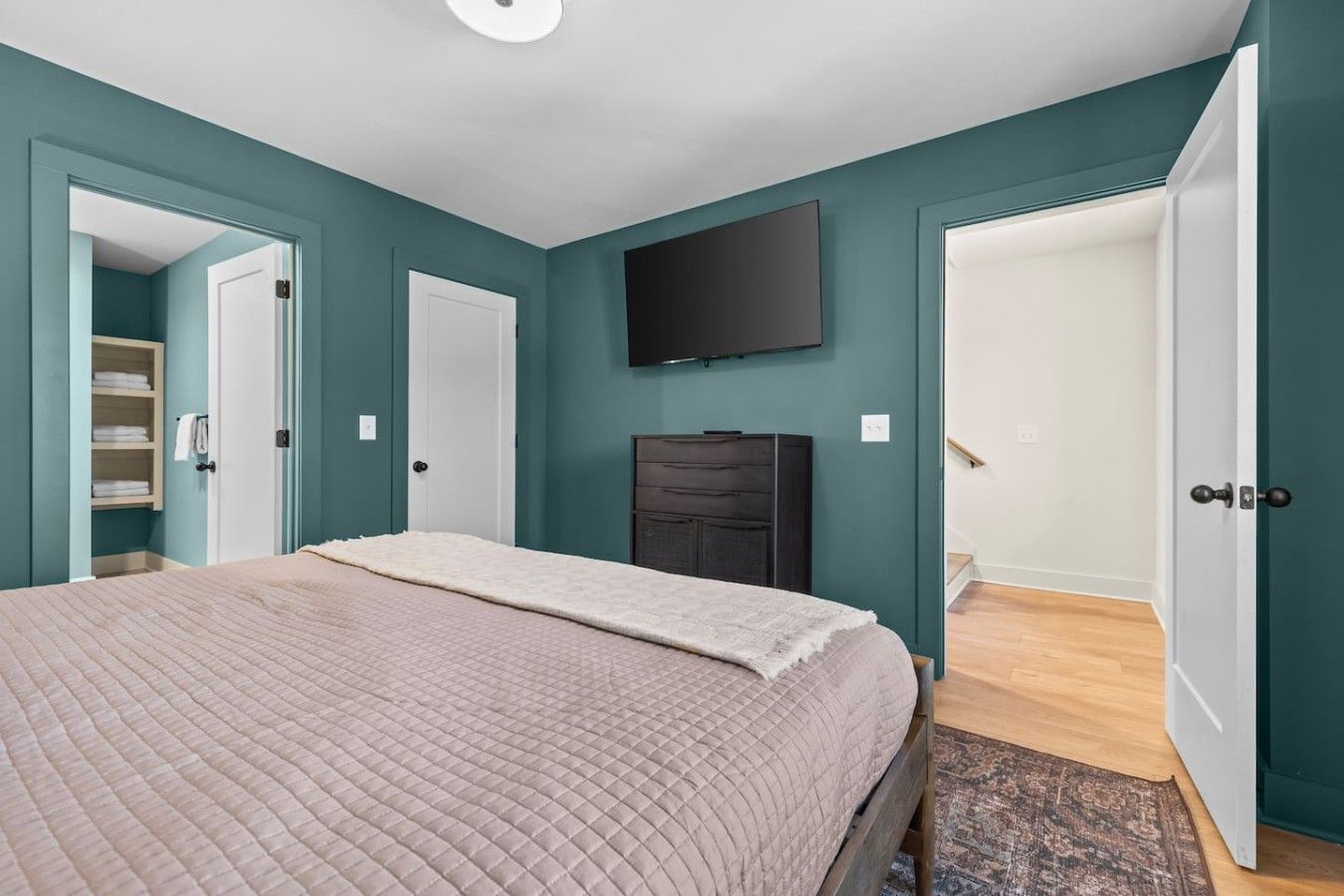 Bedroom 3 features a comfortable King bed, Smart TV, dresser, closet, and a private attached bathroom. Located on the 3rd floor.