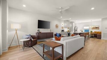 A modern living room with a sofa, coffee table, and floor lamp.