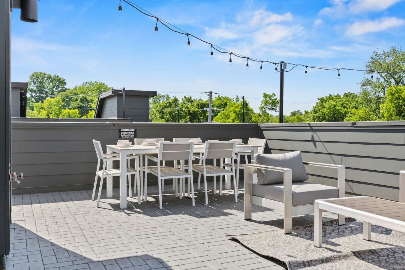 Private rooftop with comfortable outdoor furniture, dining table, BBQ, and a Smart TV—perfect for relaxing, entertaining, or enjoying the fresh air.