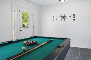 A pool table with balls and cues, a door with glass panels, and a wall with abstract designs. - Spacious 3BR w/ Fenced Yard, Near Austin Downtown (Austin)