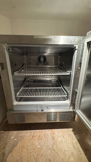 A stainless steel commercial oven with two shelves, ventilation grilles, and a control panel. - Tiny home with gazebo (San Rafael)