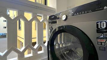 Un lave-linge à chargement frontal, muni d’un autocollant indiquant une garantie de 10 ans sur le moteur.