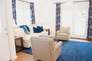 A room with a bed, a chair, a nightstand, and a door. - Child-Friendly Retreat Near Charleston, 2 (Hanahan)