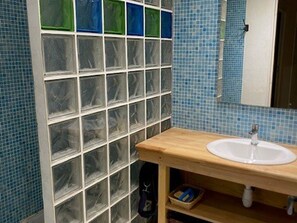 A bathroom with a tiled wall, a wooden vanity, and a mirror. - Practical studio, balcony & chalet view - 8 guests (Arette)