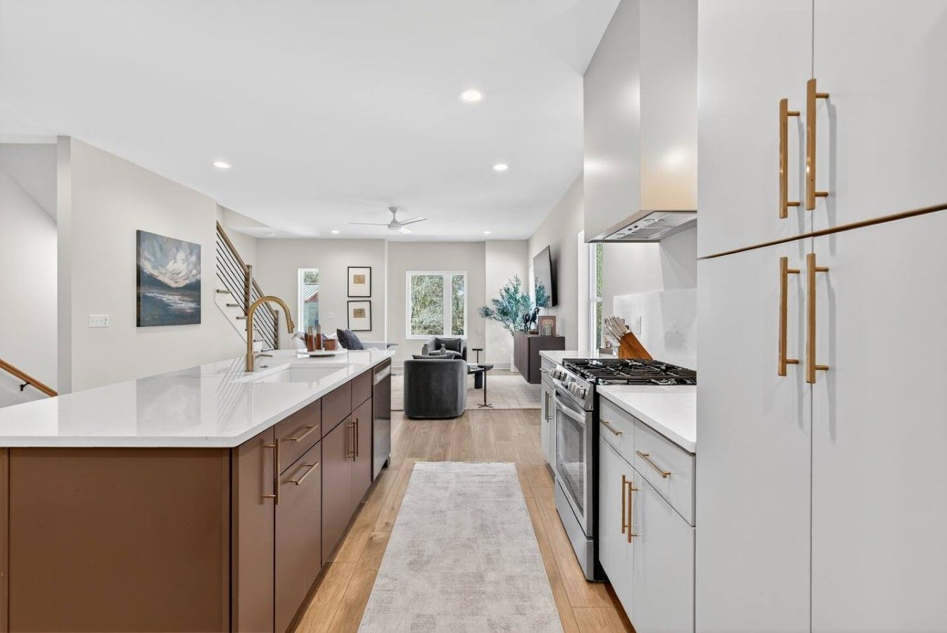 A modern kitchen with a central island, stainless steel appliances, and wooden cabinetry.