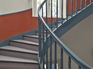 A staircase with a handrail and steps, leading to an upper floor. - T2 Apartment in the city center (Cauterets)