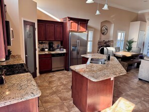 A kitchen with granite countertops, stainless steel appliances, and wooden cabinets. - Beautiful 3-bedroom 2 Bath house with AC in charming El Paso (El Paso)