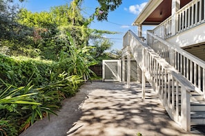 A pathway leading to a gated entrance with a wooden staircase. - Carriage House: No Cleaning/Pet Fees Soaking Tub Pet Friendly (Galveston)