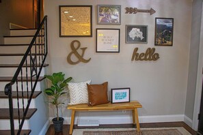 A staircase with a wooden handrail, a bench with cushions, and a potted plant. - 3BR house in charming Columbia close to USC, Fort Jackson and Prisma Health (Columbia)