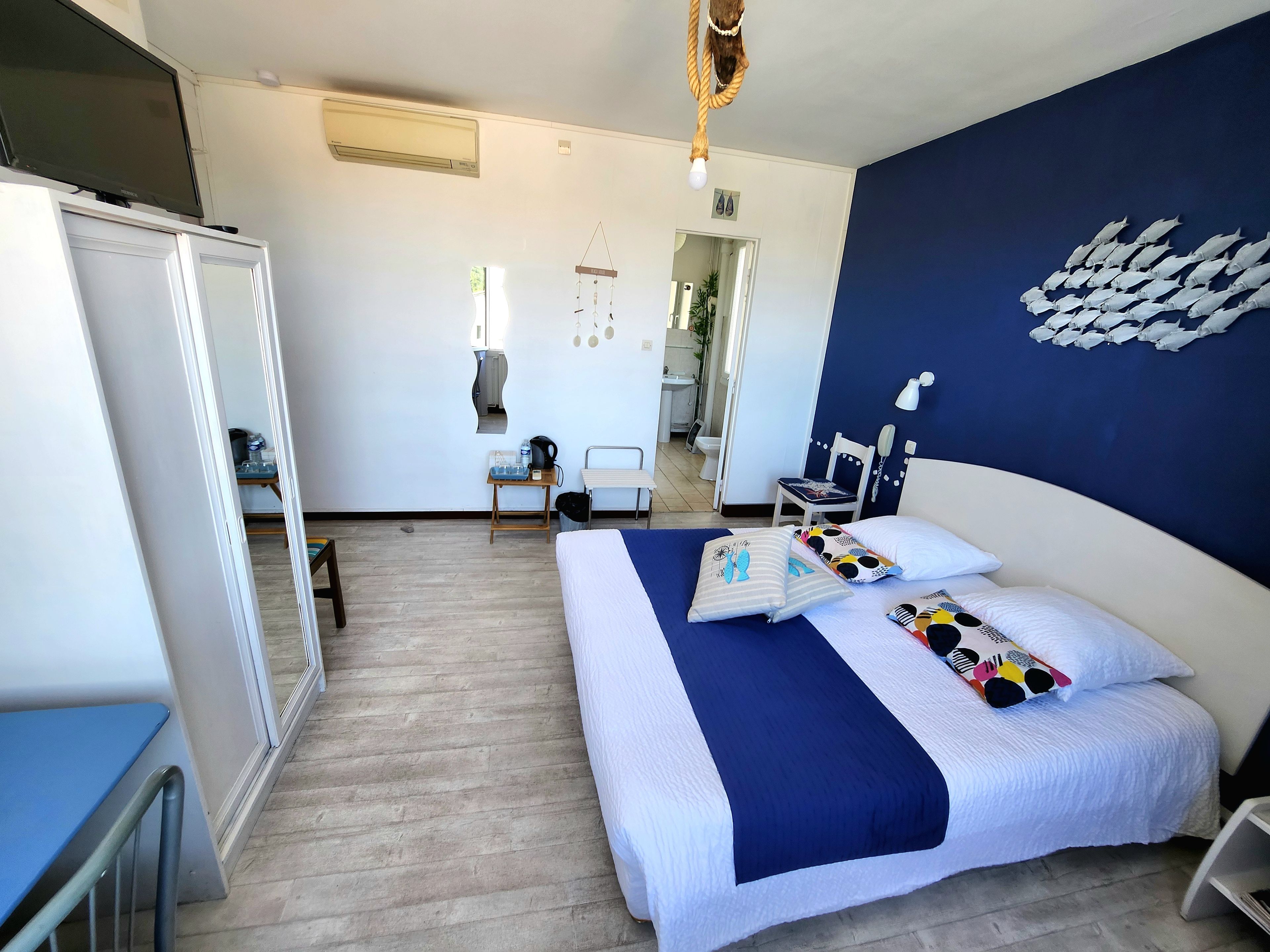 Une chambre d’hôtel avec un lit, une table de chevet et vue sur la salle de bain.