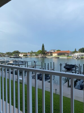 A marina with boats docked, a grassy area in the foreground, and buildings in the background. - Luxury Waterfront Condo in Clearwater Beach 3 bedroom 3 full bath (Clearwater)