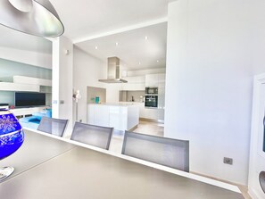 A modern kitchen with white cabinetry, a central island, and built-in appliances. - EstrellaDelSur/OceanWiew/Heatpool/By Kalmacanaria (Mogán)