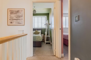A hallway leading to a bedroom with a bed, a ladder, and a radiator. - Gemstone Diamond - Coop LIVE - Etihad - Free Parking - Pool table (Greater Manchester)
