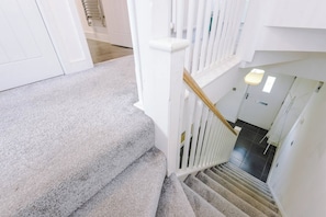 A staircase with a white handrail and carpeted steps leading to an upper floor. - Gemstone Diamond - Coop LIVE - Etihad - Free Parking - Pool table (Greater Manchester)