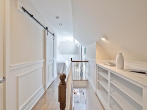 Hallway with staircase and doors to adjoining rooms - Harbor-View Condo w/ Sun Deck near Cape May (Cape May)