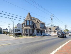 A two-story house with a gabled roof and a front porch. - Harbor-View Condo w/ Sun Deck near Cape May (Cape May)