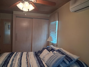A bedroom with a bed, a ceiling fan, a window with blinds, and an air conditioning unit. - Fenced Beach House w/ Deck & BBQ | Nr Delaware Bay (Villas)