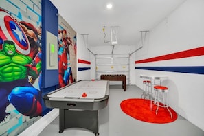 A room with a foosball table, a projector, and a red carpet. - EV_9085 - 5 Bed 5 Bath Villa with Private Pool with Spillover Spa, Custom Games (Davenport)