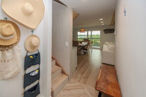 A hallway leading to a dining area with a view of greenery outside. - Santa Clara: Modern 3BR Harborfront Retreat with Safety Harbor Club Access (Captiva)