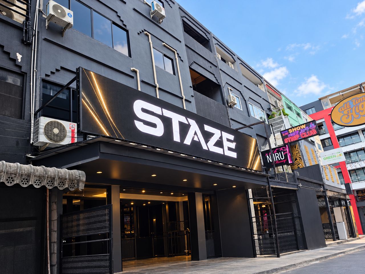 A building with a large sign reading 'STAZE' and another sign for 'N.R.U Massage'.